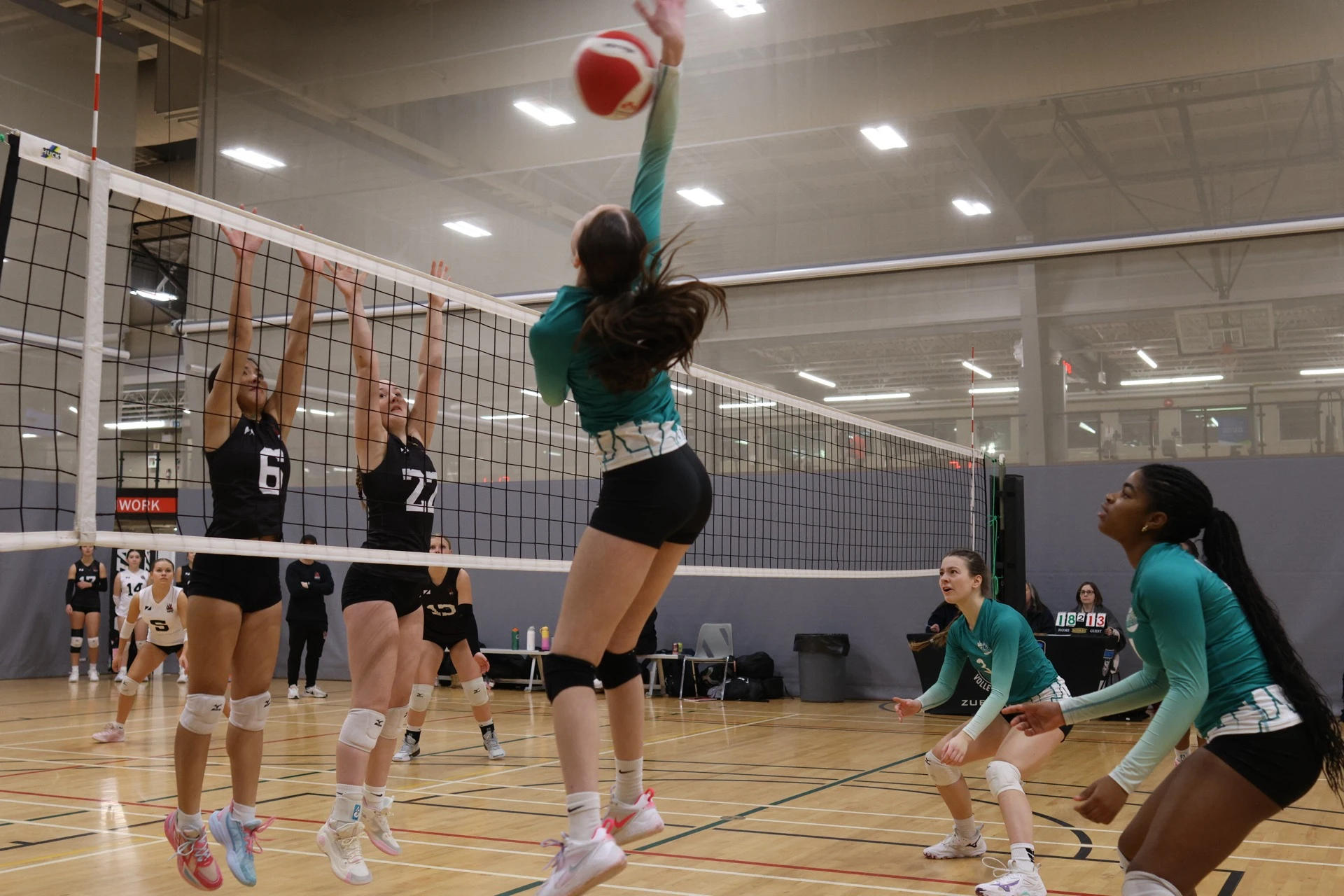 Coach providing individual feedback to a young athlete