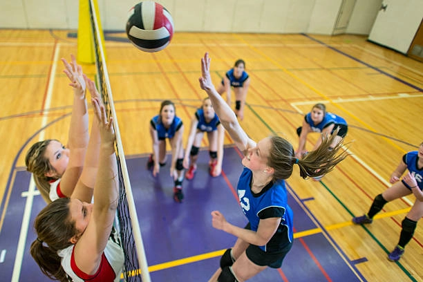Volleyball players competing and training in action